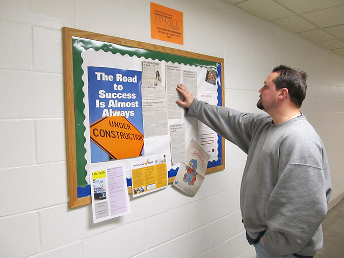 Man looking at bulletin board