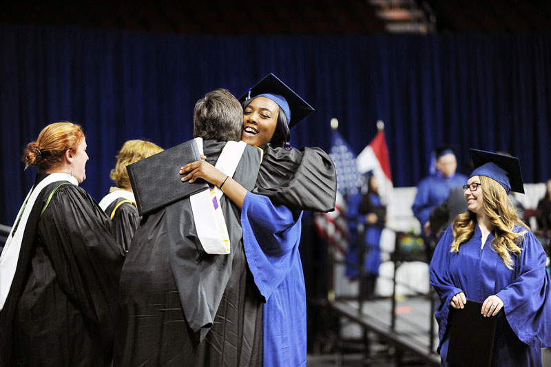 Graduate hugging a mentor