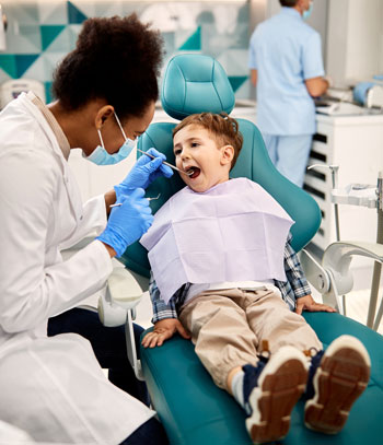 Dental Hygienist checking a child's teeth. Dental Hygienist checking a child's teeth.