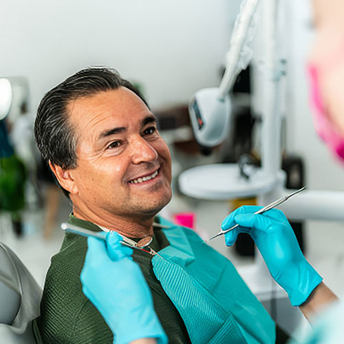 A man smiling as he gets ready for a dental exam A man smiling as he gets ready for a dental exam