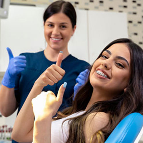 Hygienist and patient giving a thumbs up Hygienist and patient giving a thumbs up