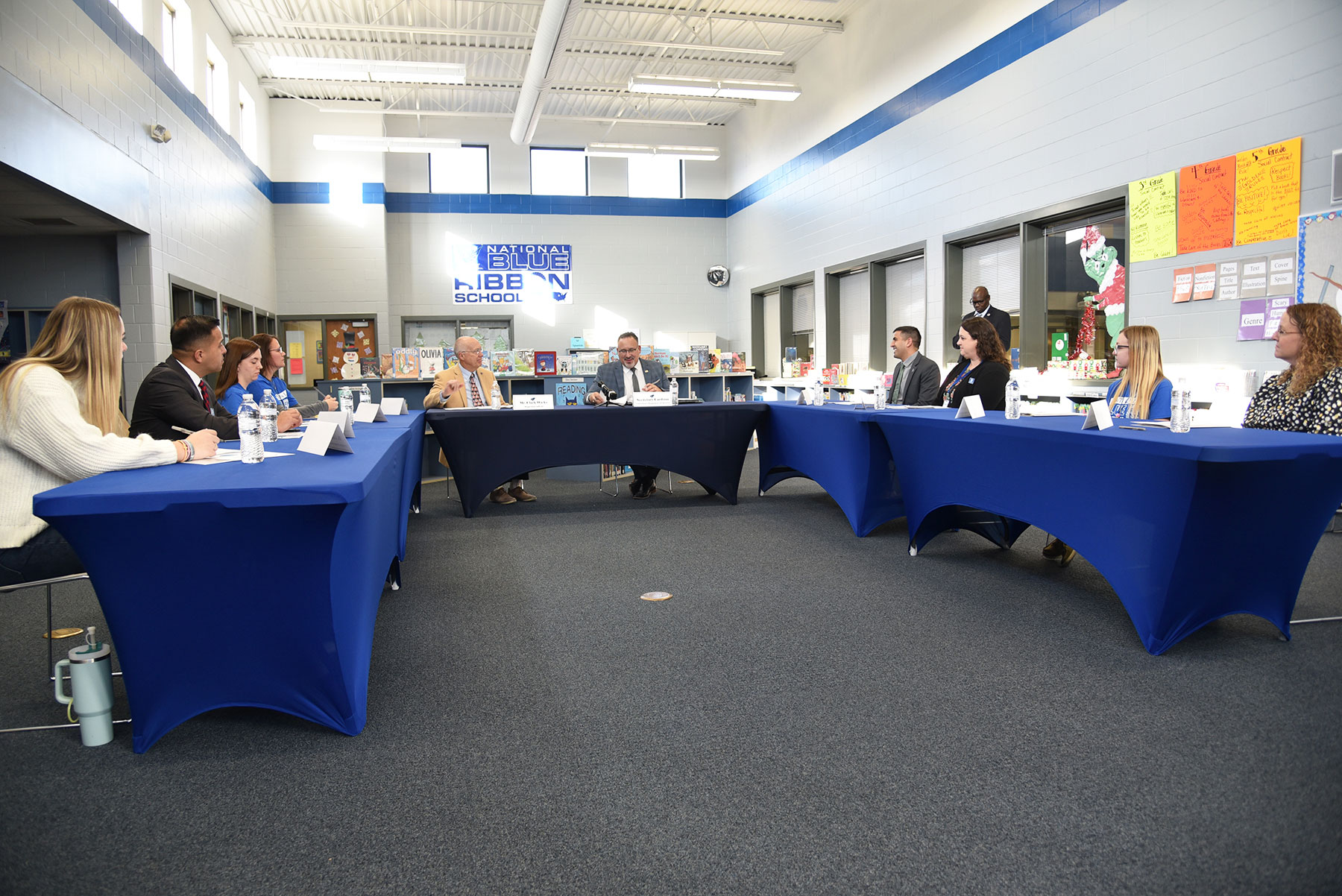 After taking a tour and visiting classrooms at Perry Elementary School, U.S. Secretary of Education Dr. Miguel Cardona participates in a 45-minute roundtable discussion focused on the nationwide shortage of teachers, as well as on Perry's successful paraeducator-teacher apprenticeship program and partnership with DMACC.