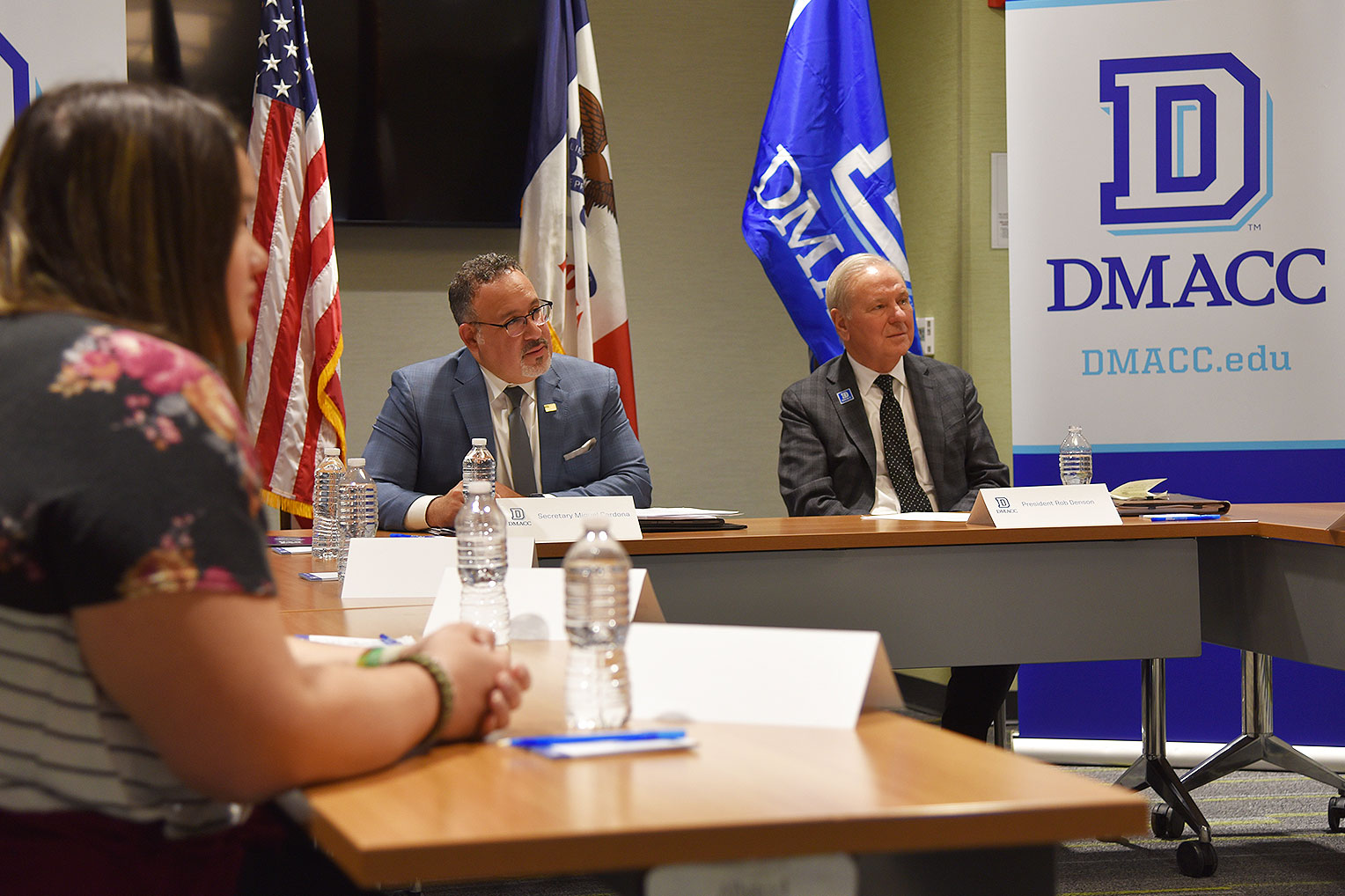 U.S. Secretary of Education Dr. Miguel Cardona (left) and DMACC President Rob Denson (right) listen intently as DMACC Education students talk about their experiences and how the DMACC Paraeducator Certificate Program has helped them overcome challenges and pursue their goal of working in education.