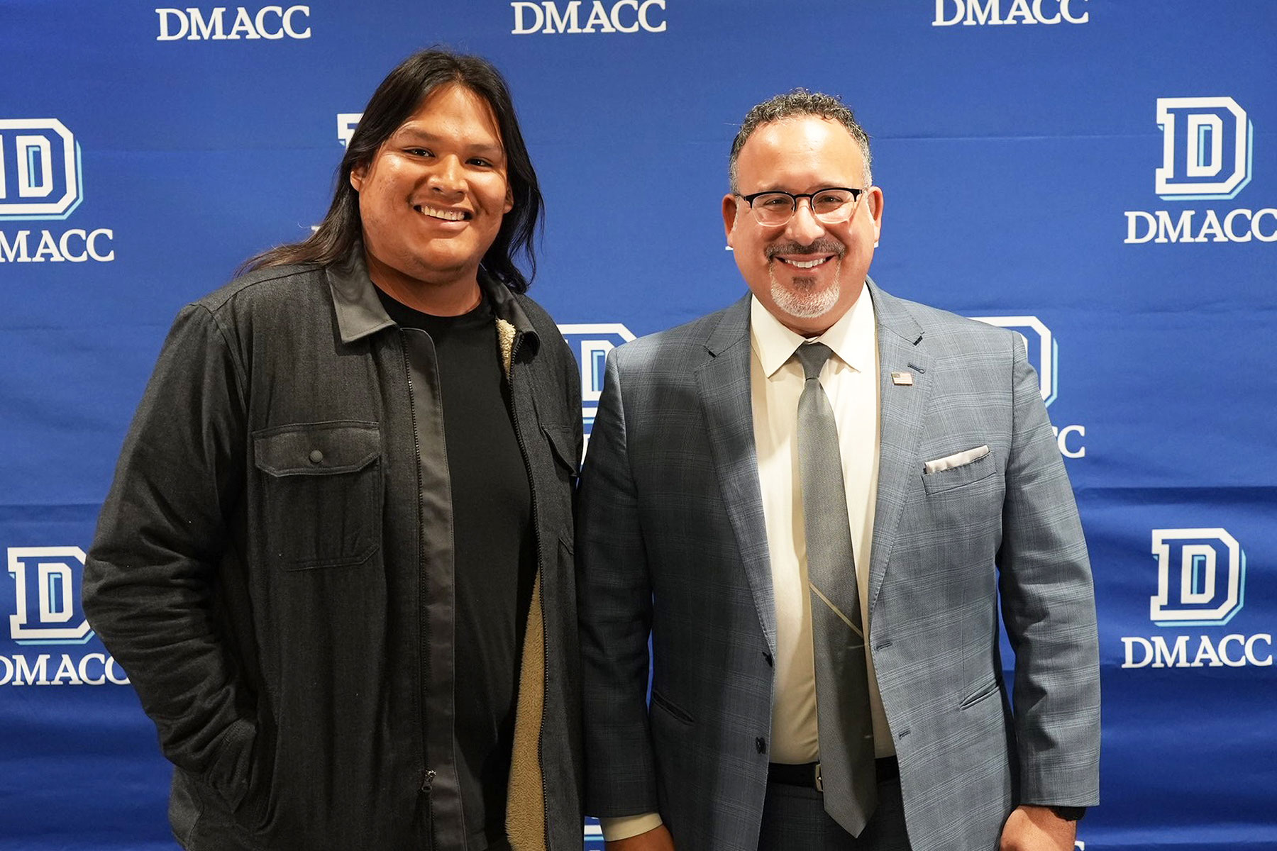 Second-year DMACC Education student Jay McCord (left) of Perry joins U.S. Secretary of Education Dr. Miguel Cardona for a photo on Dec. 7, 2023, at the DMACC Ankeny Campus.   "I want to give students a reason to come to school and be able to serve as a positive role model for students who don't have one," said McCord, who has worked as a paraeducator in the Perry Community School District for the past three years and is currently furthering his education at DMACC.